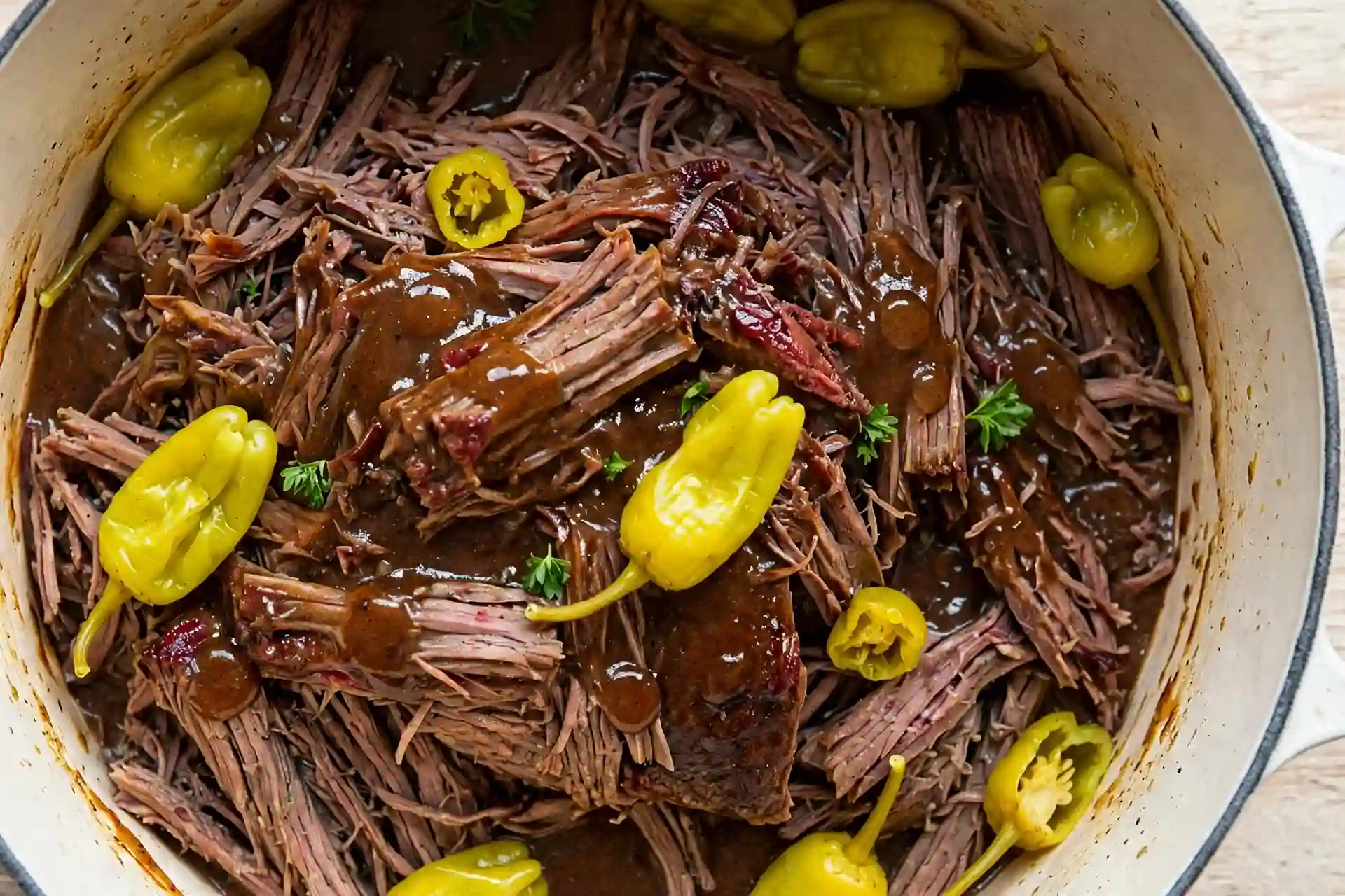 Shredded Mississippi pot roast in buttery gravy with pepperoncini peppers