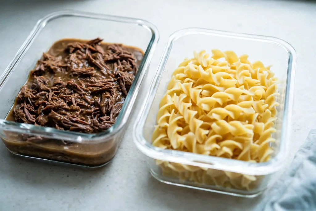 Beef and Noodles 4 Leftover beef and gravy stored separately from egg noodles in glass meal prep containers